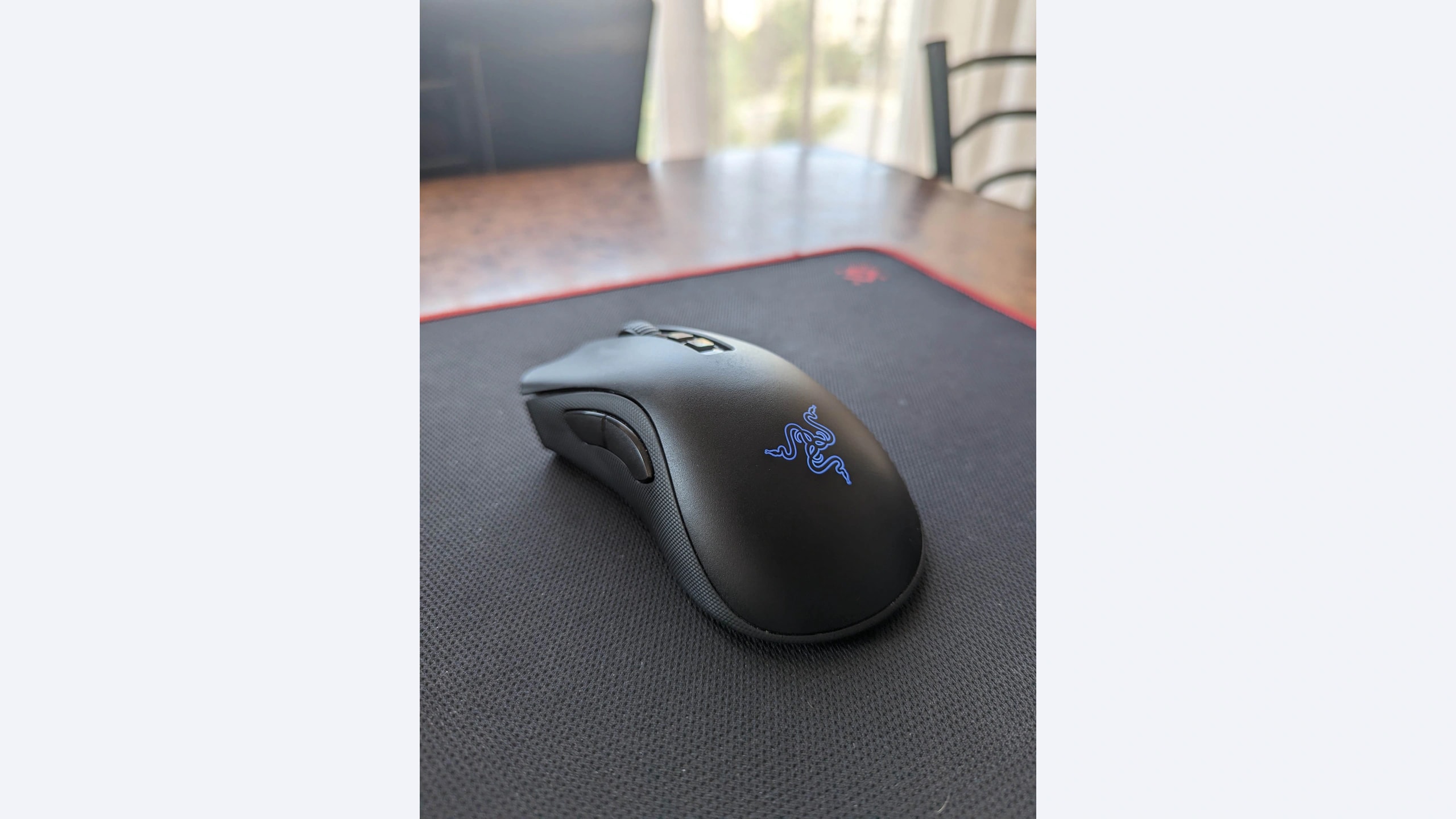 Razer DeathAdder V2 Pro wireless mouse photographed on a black mouse pad